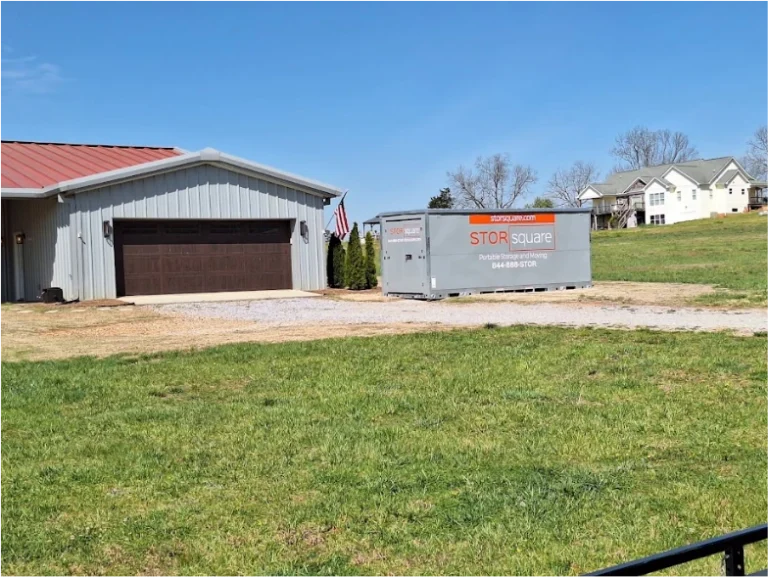 STORsquare portable storage unit placed on a gravel area beside a residential building in Cornelia.