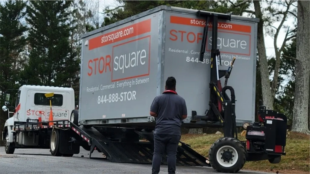 STORsquare portable storage unit being unloaded from a delivery truck with placement equipment in Harriman.