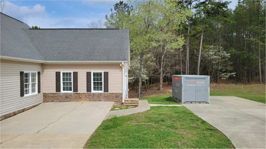 STORsquare portable storage unit placed on a side driveway beside a Kingston home.