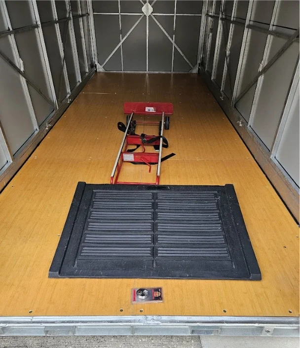 Interior of a STORsquare portable storage unit with a loading ramp and hand truck in Lake Wales.