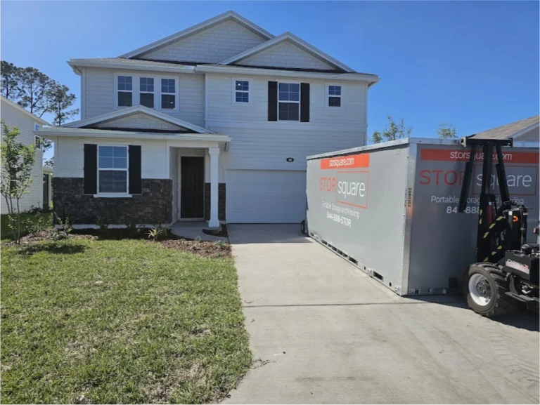 STORsquare portable storage unit placed on a residential driveway in Mocksville with delivery equipment nearby.