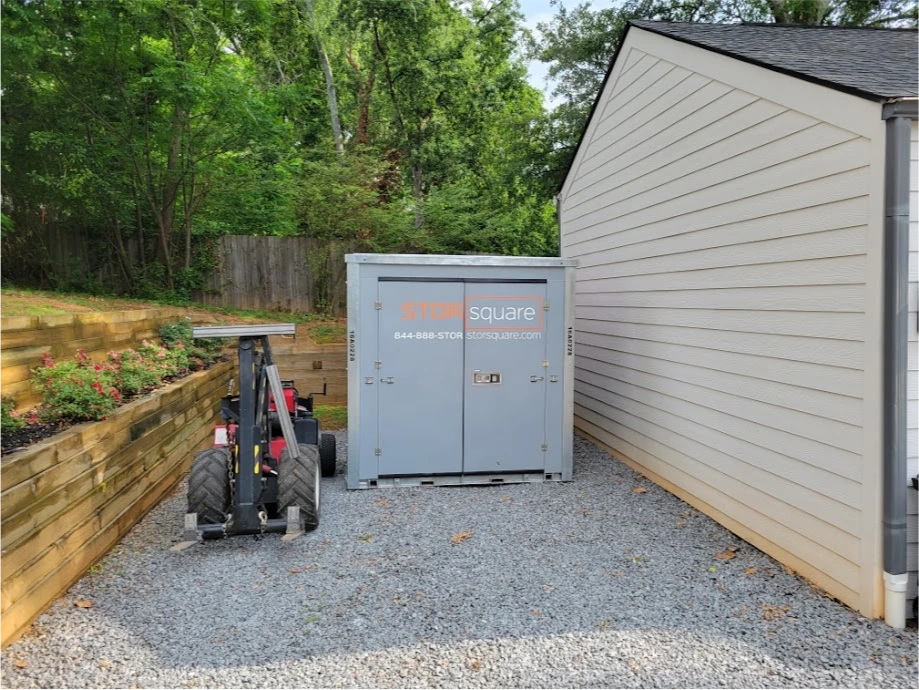 STORsquare portable storage unit placed in a tight gravel area beside a Thomasville, NC home.