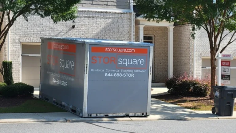 STORsquare storage container placed in a Kodak townhome driveway near a for sale sign.