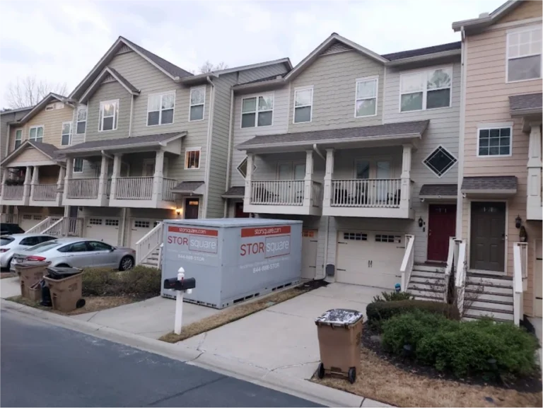 STORsquare storage container placed in a townhome driveway with garages and parked cars in Seymour.
