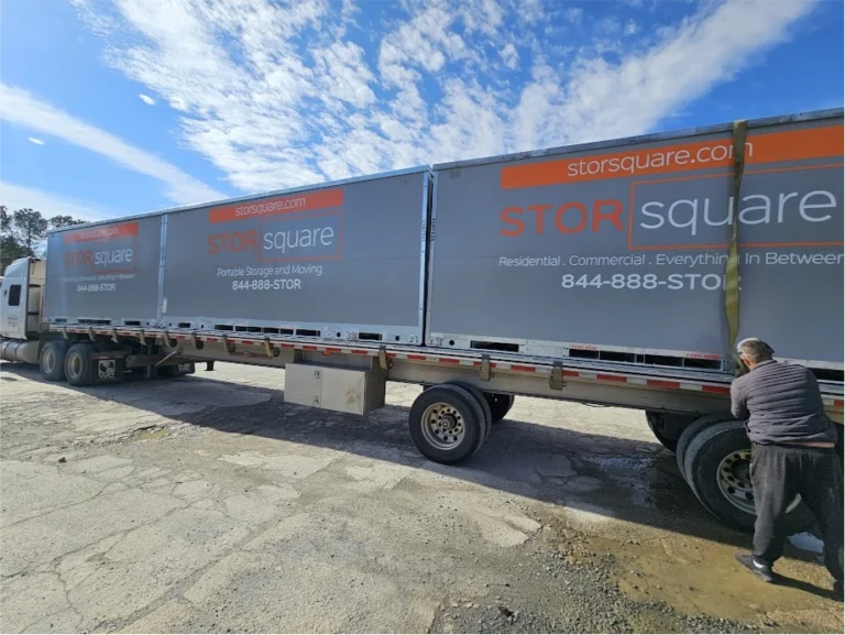 Multiple STORsquare portable storage containers secured on a transport trailer for customers in Bloomingdale, FL.