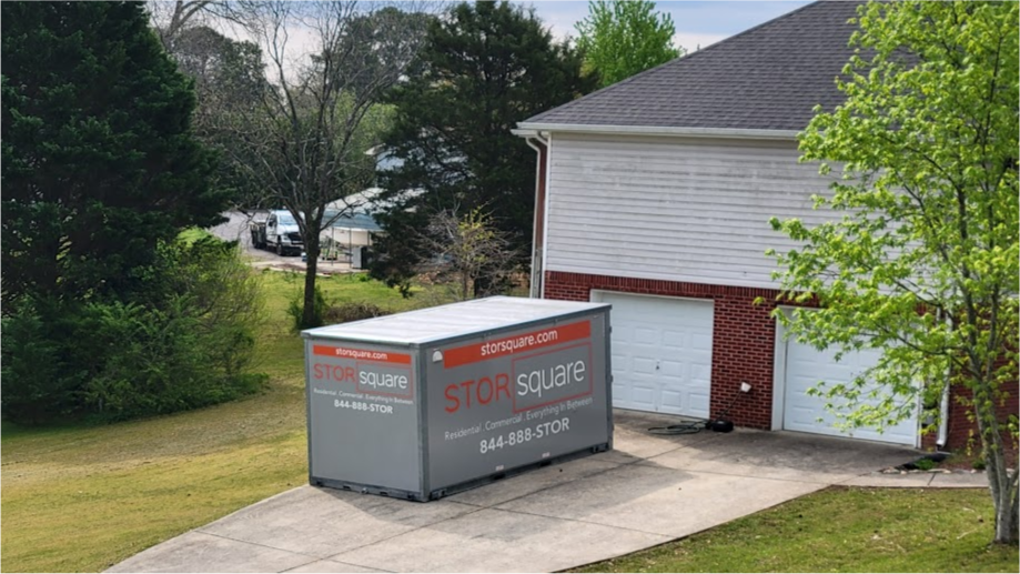 STORsquare portable storage container placed in a residential driveway beside a garage for customers in Acworth, GA.