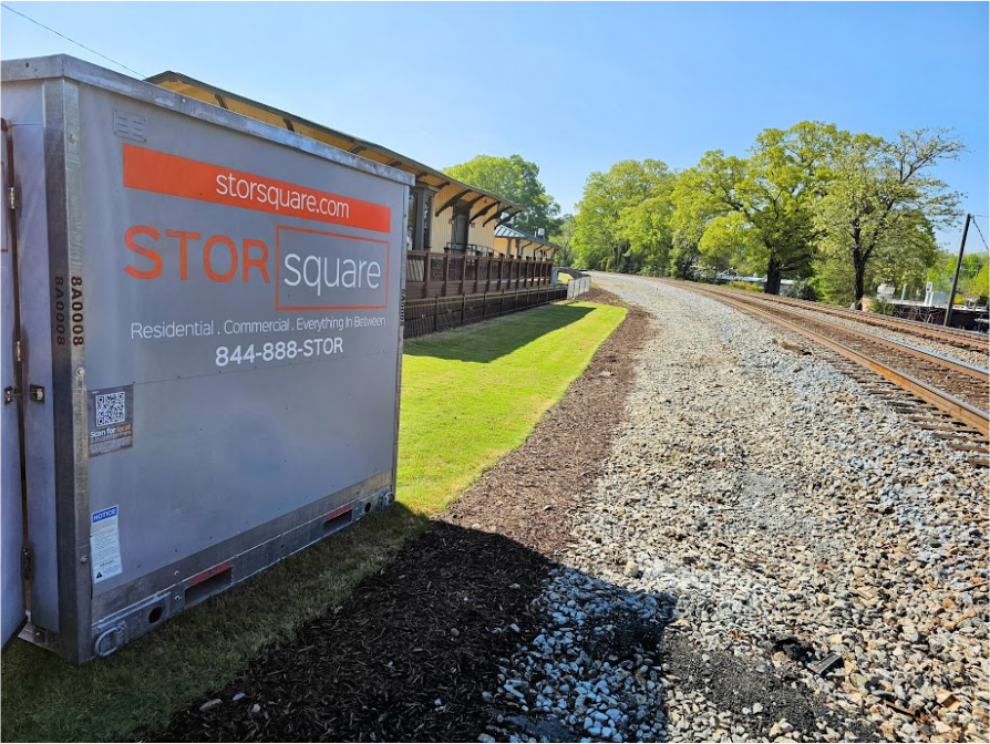 STORsquare portable storage container positioned beside railroad tracks for customers in Austell, GA.