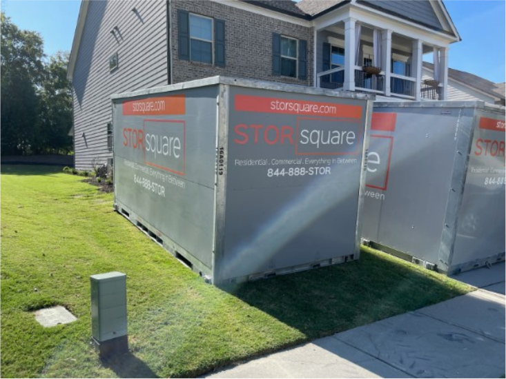 Multiple STORsquare portable storage containers placed beside a residential home for customers in Austell, GA.