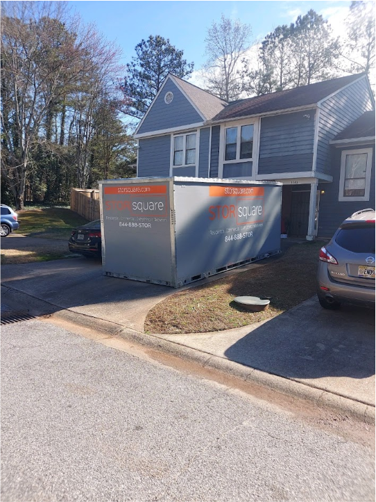 Two STORsquare portable storage containers placed in a residential driveway beside a home for customers in Clarkesville, GA.
