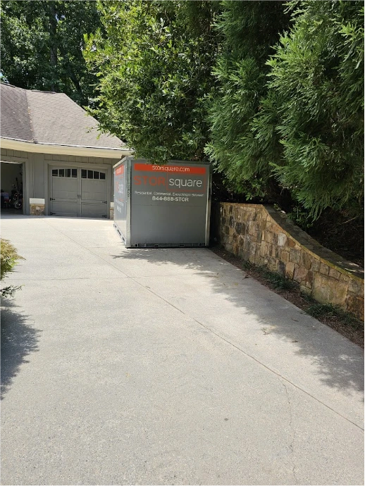 STORsquare portable storage unit placed beside a residential garage for customers in Mount Holly, NC.