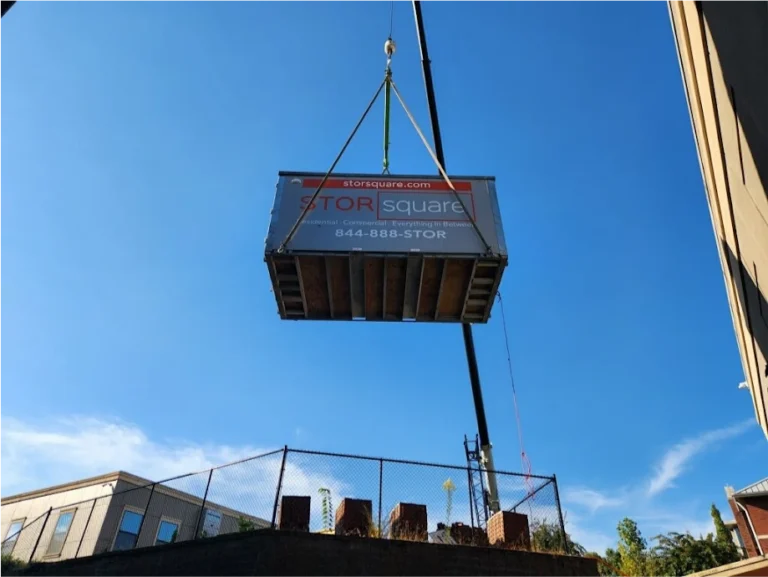 STORsquare storage container being lifted by crane for elevated placement at a property in Celebration, FL.
