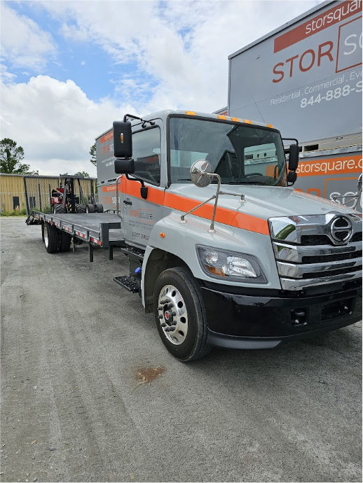 STORsquare delivery truck carrying the MULE system beside portable storage containers in Madison, GA.