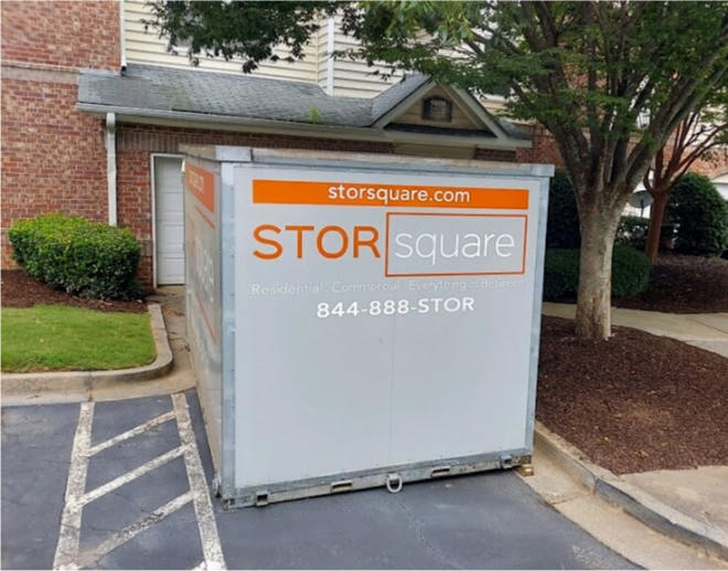 STORsquare portable storage container positioned in a paved parking area beside a residential building in Kings Mountain, NC.