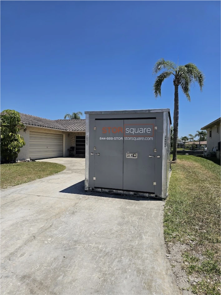 STORsquare portable storage container on a curved residential driveway beside a home for customers in Lockhart, FL.