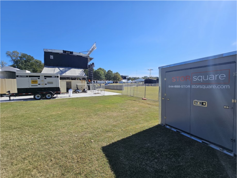 STORsquare portable storage container positioned on a grassy outdoor venue near event equipment in Madison, GA.