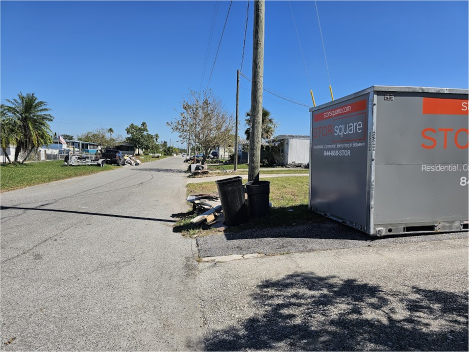 STORsquare portable storage container positioned beside a quiet residential street near utility poles, serving Doctor Phillips, FL.
